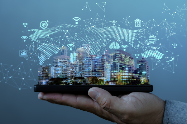 A hand holding a digital image of a city with a background of a map of the world